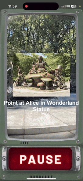 Phone screen showing the Walkie-Talkie Time Machine app pointed at the Alice in Wonderland statue in Central Park, with an AR Jabberwock appearing on the Mad Hatter's hat